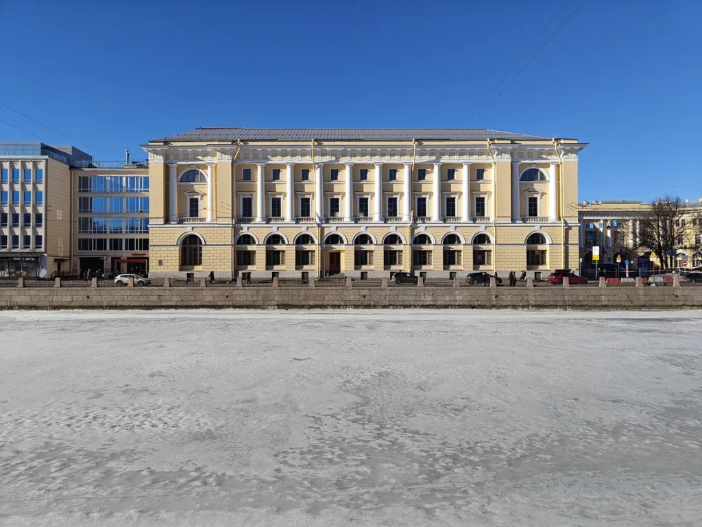 Frozen canal and classical embankment buildings in Saint Petersburg, Russia in winter